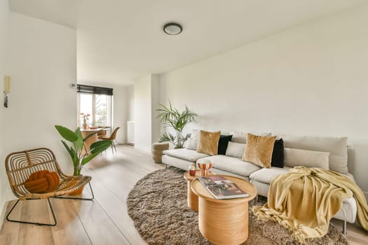 A serene modern living room featuring cozy furniture, soft textures, and natural light, creating a warm inviting atmosphere for relaxation.