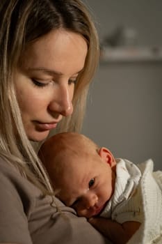 A mother cradles her baby gently in a warm and peaceful indoor space, fostering a close connection through soft touches and loving gazes.