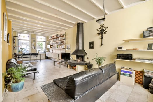 A contemporary living area featuring sleek furniture, warm lighting, and artistic elements that create a cozy ambiance, ideal for relaxation or gatherings.