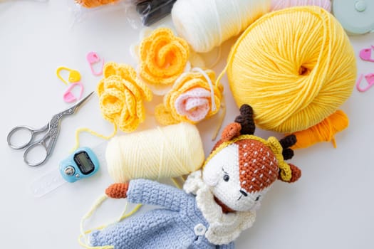 Crafting essentials. Yarn balls, crochet tools, and handmade toy.