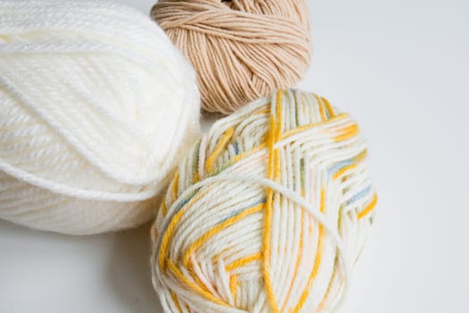 Colorful yarn collection on white background.