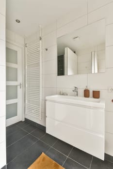 A sleek and contemporary bathroom featuring a stylish vanity, large mirror, and elegant fixtures on a minimalist backdrop.