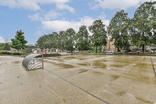 A serene urban park featuring lush green trees, a modern pavilion, and a smooth pavement leading through the peaceful environment, ideal for relaxation.