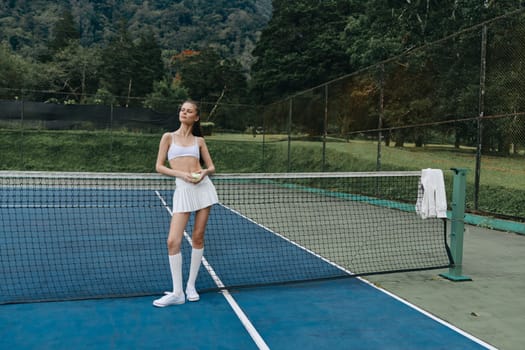 Energetic young woman in fashionable tennis attire exuding confidence on a court, surrounded by lush greenery, ideal for sports, fitness, and healthy lifestyle visuals