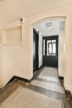 A stylish indoor entrance featuring sleek black doors and polished flooring, creating a sophisticated entryway atmosphere.