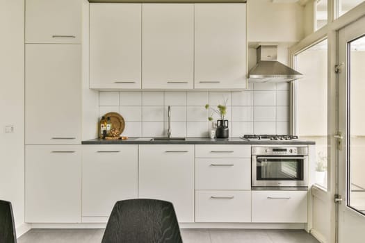 Sleek white cabinetry and contemporary appliances create a clean and functional kitchen space, perfect for modern living and cooking.