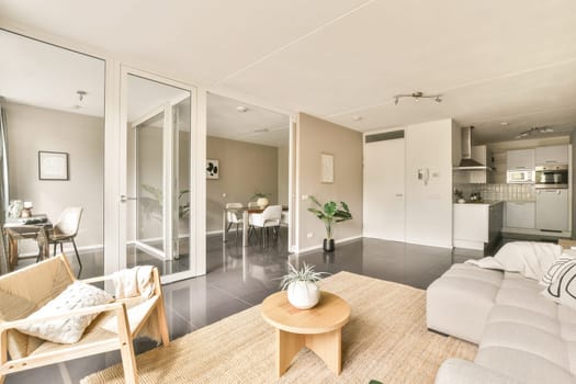 A stylish and modern living room featuring a comfortable sofa, a wooden coffee table, and tasteful decor, creating a welcoming atmosphere for relaxation.