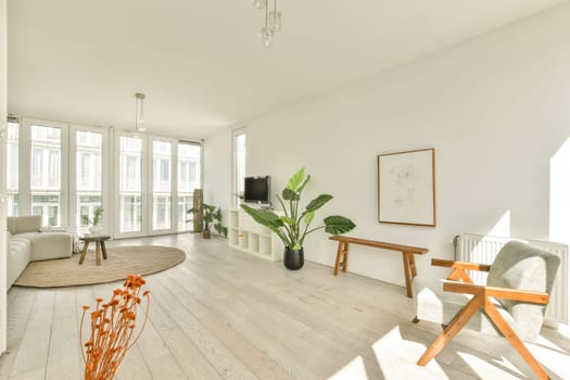 A bright and airy modern living room featuring minimalistic decor, large windows, plants, and stylish furniture, creating a serene atmosphere filled with natural light.