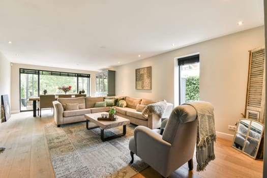 A stylish modern living room featuring a cozy seating area, elegant decor, natural light, and a warm ambiance, perfect for relaxation and socializing.
