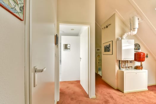 A view showcasing a modern room's interior design with a hallway, decorative elements, and contemporary furnishings. The space features clean lines and a cozy atmosphere.