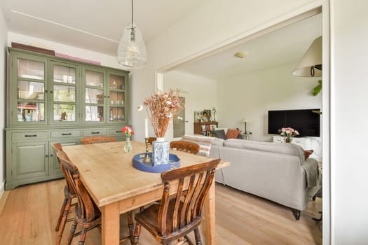 A stylish dining space featuring a wooden table, comfortable chairs, and a contemporary decor that creates a warm and inviting atmosphere.