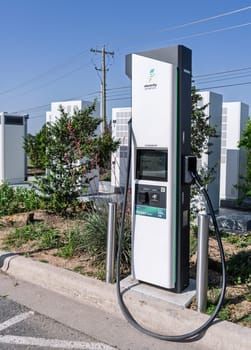 Austin, TX - 11 April 2025: Electrify America EV charging station near Georgetown Texas with power equipment behind