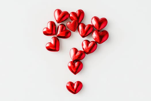 A whimsical composition features numerous shiny red hearts arranged in the shape of a question mark, sparking intrigue and emotion.
