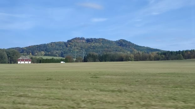 Open grassy landscape evening travel landscape nature background green grass blue sky opendoor street . High quality photo mounted shotlisttravel