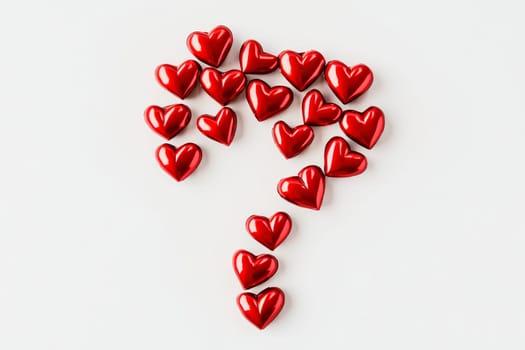A whimsical composition features numerous shiny red hearts arranged in the shape of a question mark, sparking intrigue and emotion.
