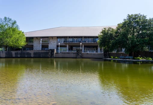 Austin, TX - 10 April 2025: Facade of Palmer Center in Town Park seen across the Palmer lake in Austin Texas