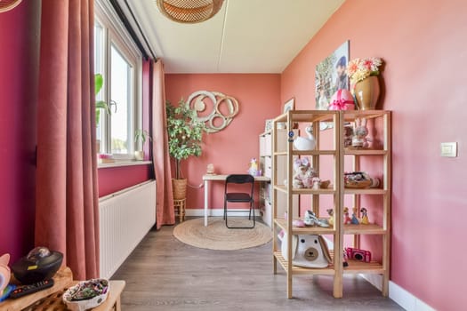 A beautifully arranged interior showcasing a warm color scheme, decorative shelving, and a cozy workspace that invites relaxation and creativity.