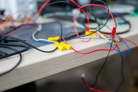 A collection of various wires is currently spread out on a table surface, creating an interesting sight for those interested in electronics