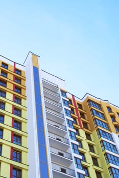 An impressive tall building featuring numerous windows along with multiple balconies for its residents to enjoy the view