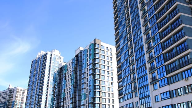 A row of tall and impressive buildings set against a bright blue sky, creating a stunning urban skyline that captures the essence of city life