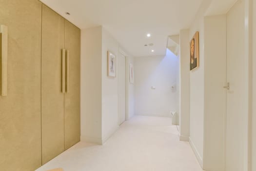 A contemporary interior hallway featuring clean lines, minimalist decor, and subtle lighting. The space creates a serene atmosphere with soft tones.