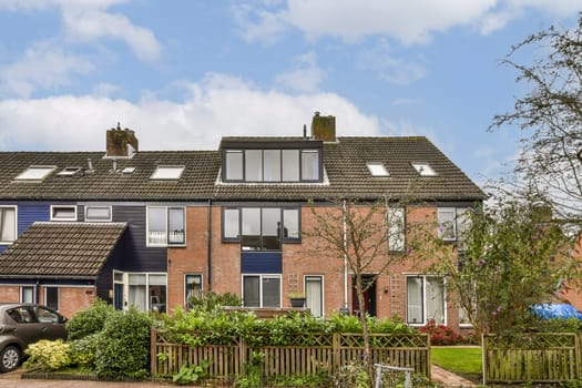 A picturesque view of townhouses showcasing a mix of brick and modern design accompanied by lush greenery and a welcoming atmosphere.