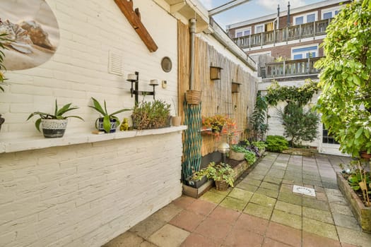 A well-designed outdoor garden area featuring greenery, decorative plants, and stylish architecture, perfect for relaxation and enjoyment.