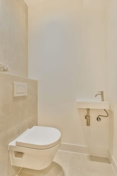 Elegant minimalist bathroom featuring a modern toilet and sleek fixtures against light tile walls, creating a clean and spacious ambiance.