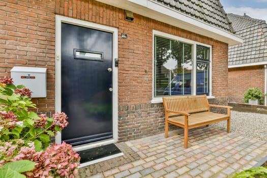 Featuring a stylish wooden bench and floral landscaping, this image showcases the inviting facade of a contemporary home.