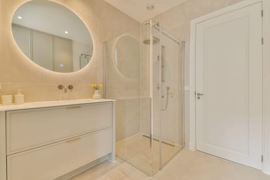 Stylish modern bathroom showcasing a sleek shower, contemporary design elements, and tasteful decor, providing a serene atmosphere.