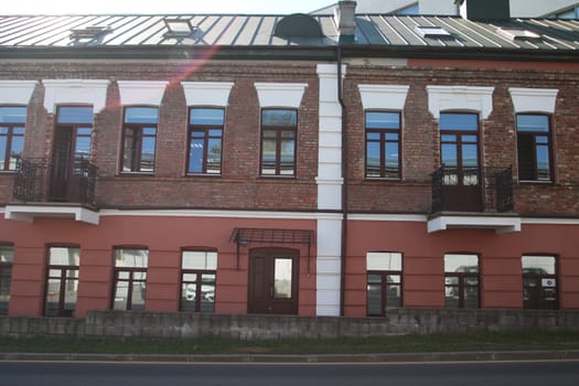 A sturdy brick building that features a charming balcony located on the second floor, providing an inviting outdoor space