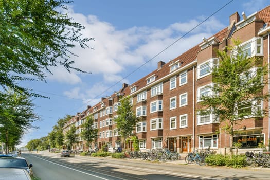 A picturesque streetscape featuring charming brick buildings, lush trees, and a peaceful road lined with greenery, creating a serene urban ambiance.