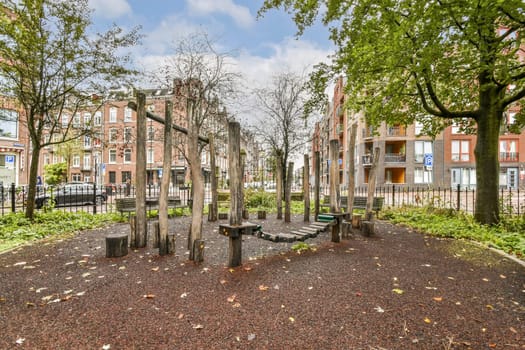 A vibrant urban playground featuring natural wood structures set against a backdrop of lush greenery and modern buildings, ideal for children and family activities.
