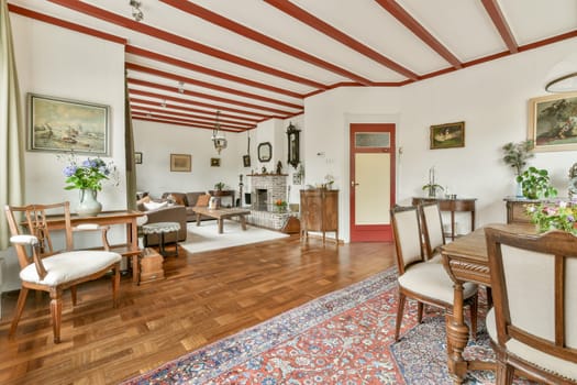A charming vintage living room showcasing elegant furniture and warm wood accents, ideal for comfort and style. Natural light enhances the inviting atmosphere.