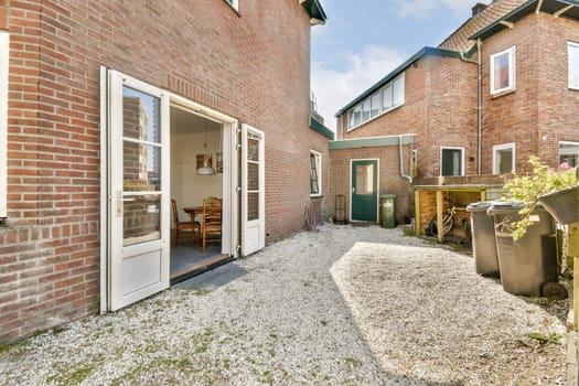 A picturesque view of a residential alley showcasing brick buildings and a well-maintained outdoor space, ideal for urban living and neighborhood aesthetics.