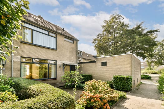 A picturesque view of a modern residential house surrounded by vibrant greenery and well-maintained gardens, showcasing a peaceful suburban setting.