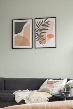 A stylish modern living room featuring abstract artwork, a cozy couch, and decorative elements creating an inviting atmosphere.