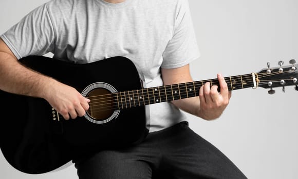 Man with a guitar in hands playing a song