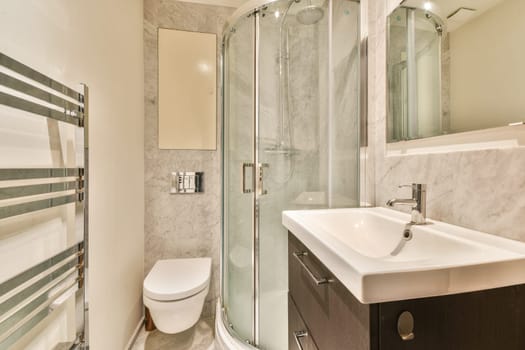 A sleek, contemporary bathroom featuring a glass shower enclosure, stylish sink, and elegant tile work for a refreshing ambiance.