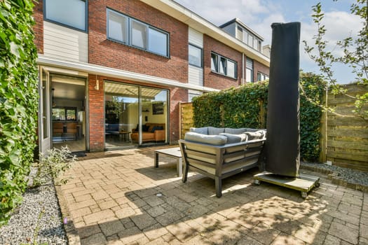 Stylish outdoor patio featuring contemporary furniture, lush greenery, and a well-designed space for relaxation and entertaining.