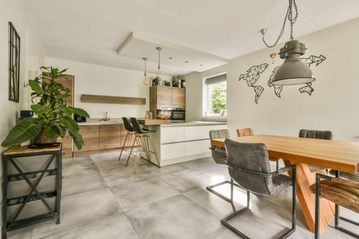 A stylish modern kitchen showcases sleek cabinetry, open shelving, and minimalist decor, creating a warm and inviting space for cooking and gathering.