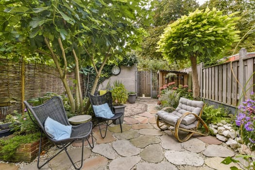 A serene garden scene featuring comfortable seating, lush greenery, and vibrant flowers, creating a peaceful outdoor sanctuary.