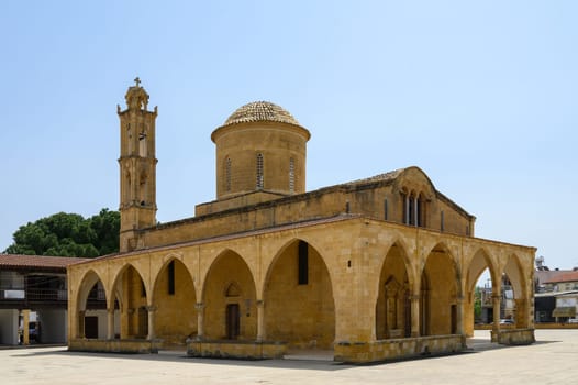 Majestic Selimiye Mosque stands proudly with its intricate arches and dome, surrounded by vibrant greenery on a sunny day in Nicosia, Cyprus. Visitors marvel at its beauty.