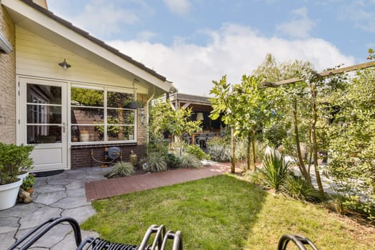 A beautifully designed garden featuring lush greenery, pathways, and cozy seating arrangements, perfect for outdoor relaxation and enjoyment.