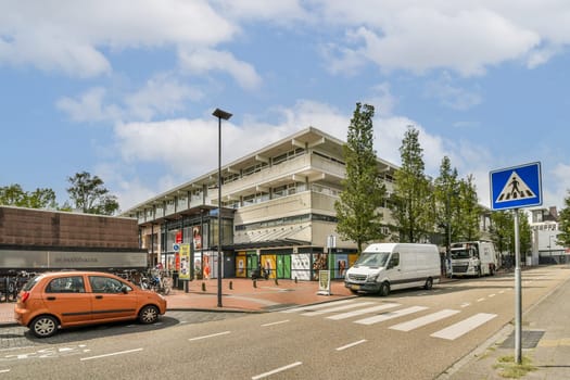 A vibrant city street scene showcasing modern architecture, vehicles, and pedestrians navigating through a busy urban environment.