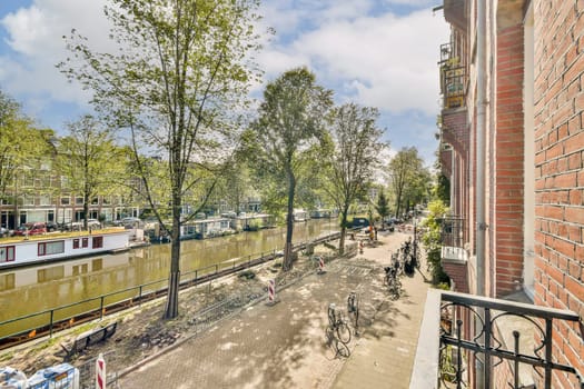 A picturesque view along a riverbank featuring vibrant greenery and charming bicycles parked beside the water, creating a serene urban landscape.