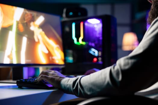 Man playing first person shooter videogame with automatic gun shooting laser bullets at flying robotic foes, close up. Professional gamer competing in PvP online multiplayer game, destroying enemies