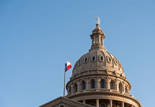 Detail of the dome of the Texas State Capitol building in Austin with sun low in the sky before sunset