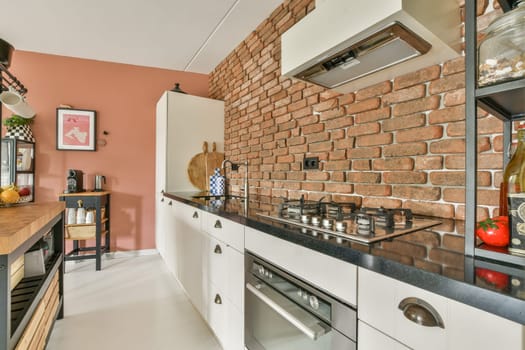 Stylish kitchen featuring modern appliances, exposed brick walls, sleek cabinetry, and a cozy atmosphere, perfect for cooking and entertaining.