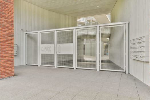 A contemporary entrance showcasing a mesh door design, featuring sleek lines and minimalist aesthetics, complemented by an industrial ambiance.